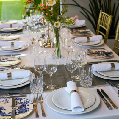 Blue Floral Crockery I Avant Garde Crockery I Carmen Cutlery I Cabernet Glassware I Crystal Whiskey Tumblers I Gold Chiavari Chairs I Rectangular Table